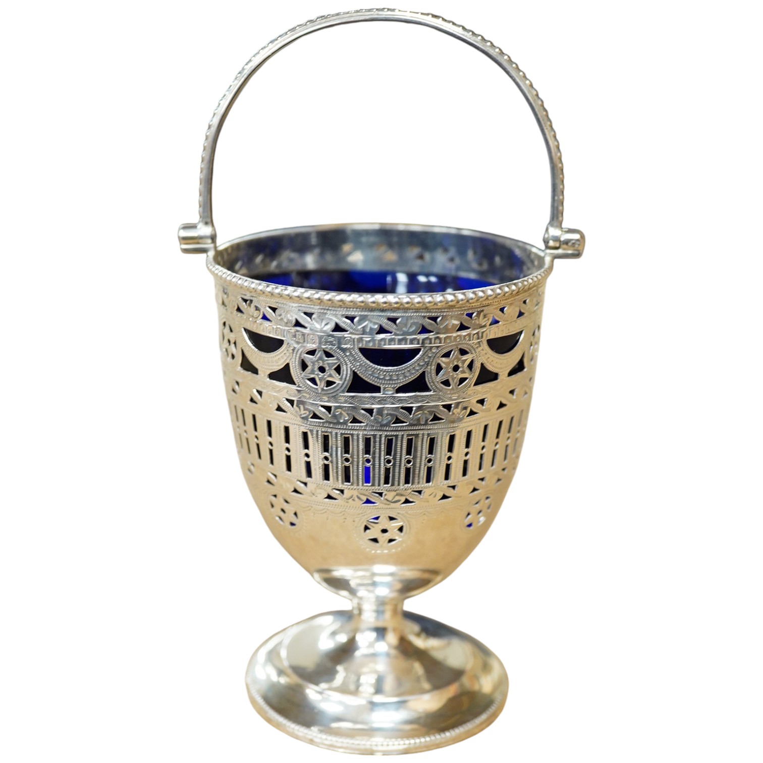 An Edwardian pierced silver pedestal sugar basket, with later? blue glass liner, Thomas Hayes, Birmingham, 1904, 11.7cm. Condition - fair to good